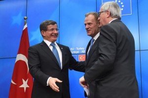 Turkey's Prime Minister Ahmet Davutoglu (L), European Council President Donald Tusk (C) and European Commission President Jean-Claude Juncker speak during a press conference at the end of an EU leaders summit with Turkey centered on the the migrants crisis, at the European Council, in Brussels on March 8, 2016.  European Union leaders will on March 7 back closing down the Balkans route used by most migrants to reach Europe, diplomats said, after at least 25 more people drowned trying to cross the Aegean Sea en route to Greece. The declaration drafted by EU ambassadors on March 6 will be announced at a summit in Brussels on March 7, set to also be attended by Turkish Prime Minister Ahmet Davutoglu. / AFP / EMMANUEL DUNAND        (Photo credit should read EMMANUEL DUNAND/AFP/Getty Images)