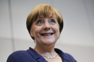 FILE - In this Thursday, July 16, 2015, file photo, German Chancellor Angela Merkel smiles as she arrives for a meeting in Berlin. Merkel has been named as Time's Person of the Year, the publication announced Wednesday, Dec. 9, 2015, praised by the magazine for her leadership on everything from Syrian refugees to the Greek debt crisis. (AP Photo/Markus Schreiber, File)