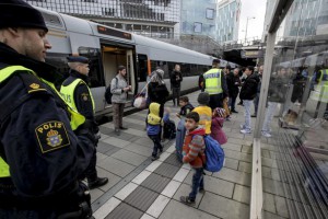 A group of migrants coming off an incoming train gather on the platform at the Swedish end of the bridge between Sweden and Denmark, in Hyllie district, Malmo, November 12, 2015. Sweden will impose temporary border controls from Thursday in response to a record influx of refugees, a turnaround for a country known for its open-door policies that also threw down the gauntlet to other EU nations hit by a migration crisis. REUTERS/Stig-Ake Jonsson/TT News AgencyATTENTION EDITORS - SWEDEN OUT. NO COMMERCIAL OR EDITORIAL SALES IN SWEDEN. THIS IMAGE HAS BEEN SUPPLIED BY A THIRD PARTY. IT IS DISTRIBUTED, EXACTLY AS RECEIVED BY REUTERS, AS A SERVICE TO CLIENTS. NO COMMERCIAL SALES. - RTS6OG3