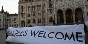 Activists hold up a banner with 'Refugees welcome' as sympathizers of several civil organizations protest against the migration policy of the Orban government in front of the parliament building in Budapest on September 30, 2016. A referendum on the European Union's migrant resettlement plans will be held on Sunday  in Hungary.   / AFP / ATTILA KISBENEDEK        (Photo credit should read ATTILA KISBENEDEK/AFP/Getty Images)